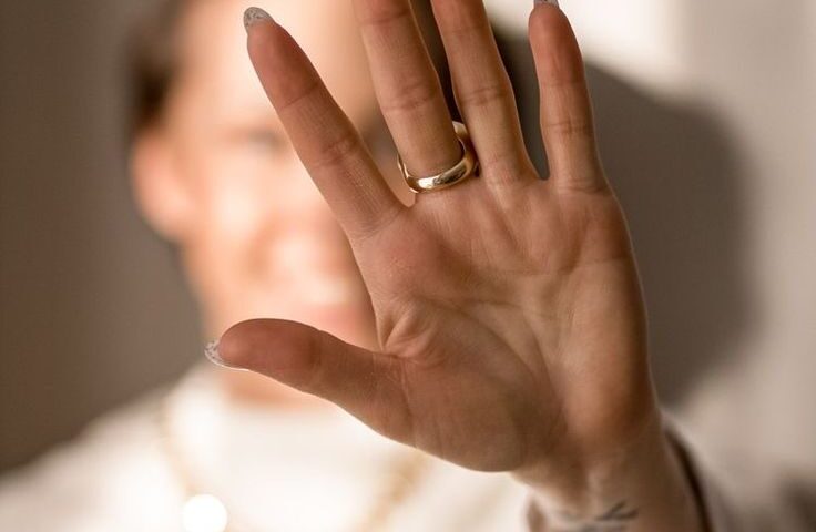 Woman holding up her hand in a stop gesture, representing pushing back against anxiety therapy myths in Chicago