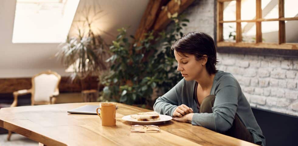 A woman sitting by the table