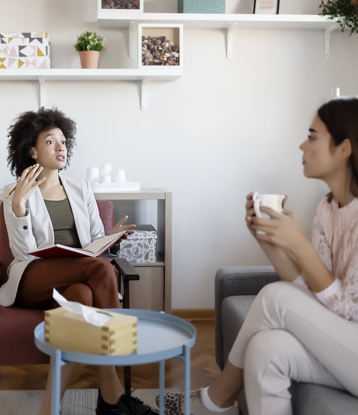 Therapist and client in a supportive conversation, reflecting the collaborative approach of feminist and social justice informed therapy in Chicago