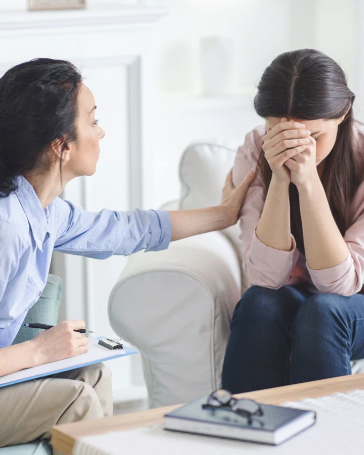 Person quietly reflecting on loss, illustrating how grief can activate trauma responses within trauma-informed, identity-informed care in Chicago